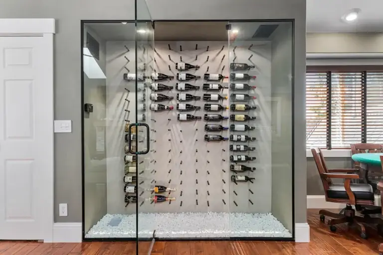 Glass-enclosed custom wine cellar with lit bottle racks