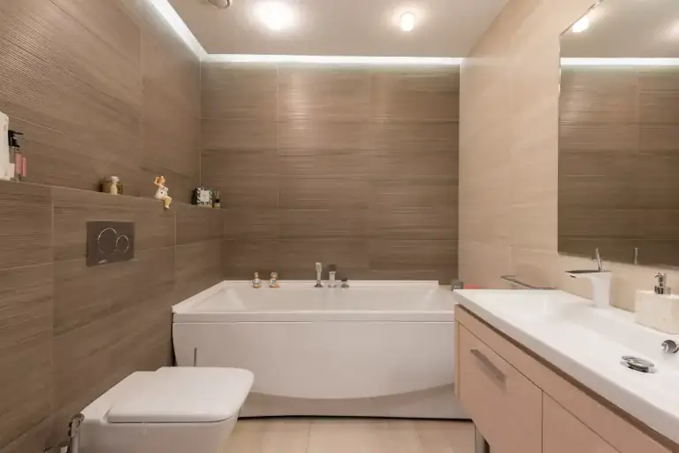 Bathroom renovation with warm wall tile and a deep soaking tub