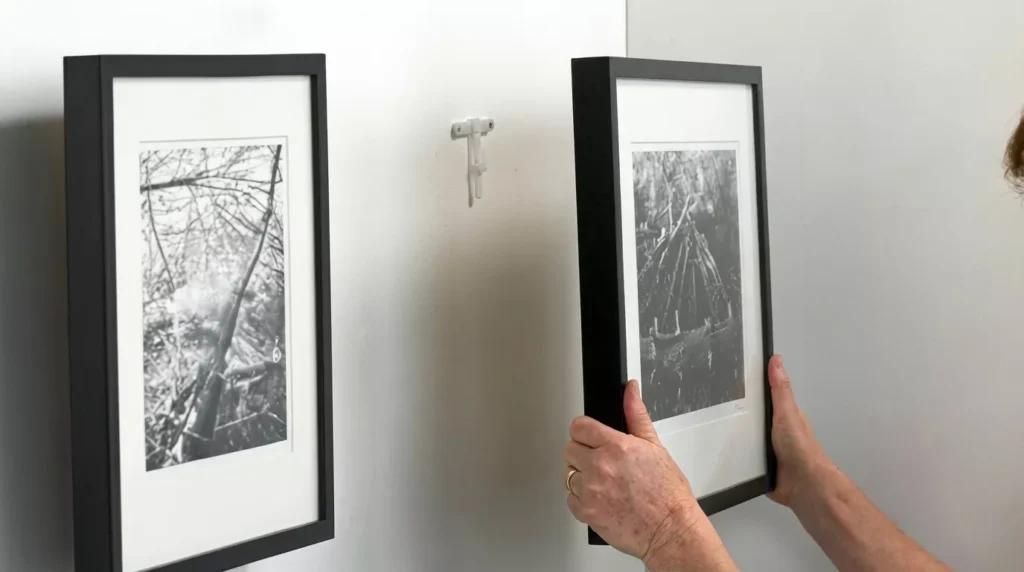 Professional Artwork & Mirror Hanging Toronto securing heavy frame by CNG Contracting.