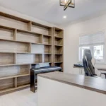 Professional Custom Shelving & Built-in Solutions Toronto installing living room wall unit by CNG Contracting.