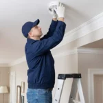 Professional Doorbells & Smoke Detector Installation Toronto testing fire alarm by CNG Contracting.