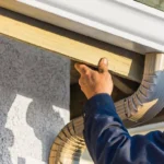 Professional Downspout Replacement Toronto installing aluminum leader pipe by CNG Contracting.