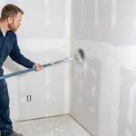 Professional Drywall Patching & Finishing Toronto repairing wall hole by CNG Contracting.