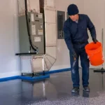 Professional Epoxy Floor Coating Toronto spreading decorative flakes by CNG Contracting.