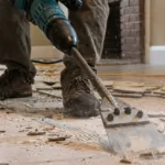 Professional Flooring Removal & Preparation Toronto scraping old tile adhesive by CNG Contracting.