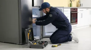 Technician performing Minor Fridge Leak Repairs and checking connections in Toronto.