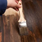 Professional Furniture Staining & Refinishing Toronto applying custom stain to wood table by CNG Contracting.