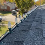Professional Holiday Lighting Installation IN Toronto attaching clips to roof gutter by CNG Contracting.