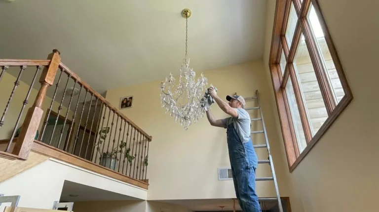 Professional Light Bulbs & Chandelier Cleaning Toronto polishing crystals on a high fixture by CNG Contracting.