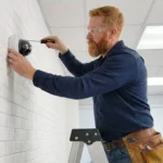 Professional Sensor Alignment Toronto adjusting garage door photo eyes by CNG Contracting.