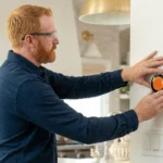 Professional Smart Home Device Installation Toronto configuring smart thermostat by CNG Contracting.