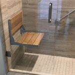 Professional Walk-In Shower & Grab Bar Installation Toronto securing safety rail by CNG Contracting.