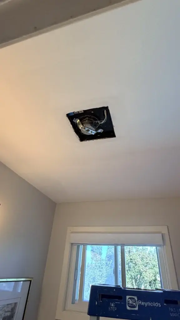 Bathroom ceiling with the old exhaust fan opening