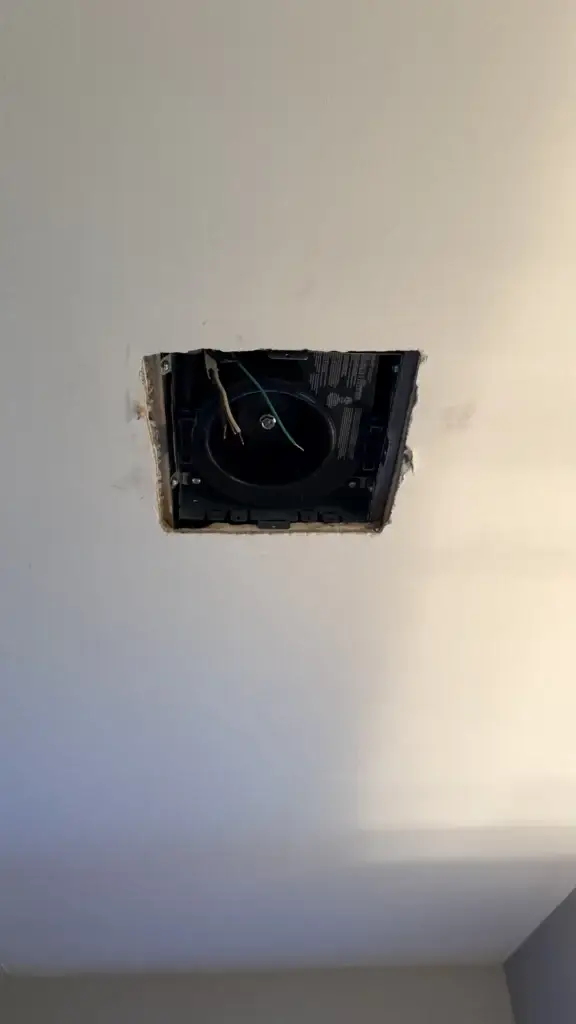 New bathroom exhaust fan housing installed in the ceiling