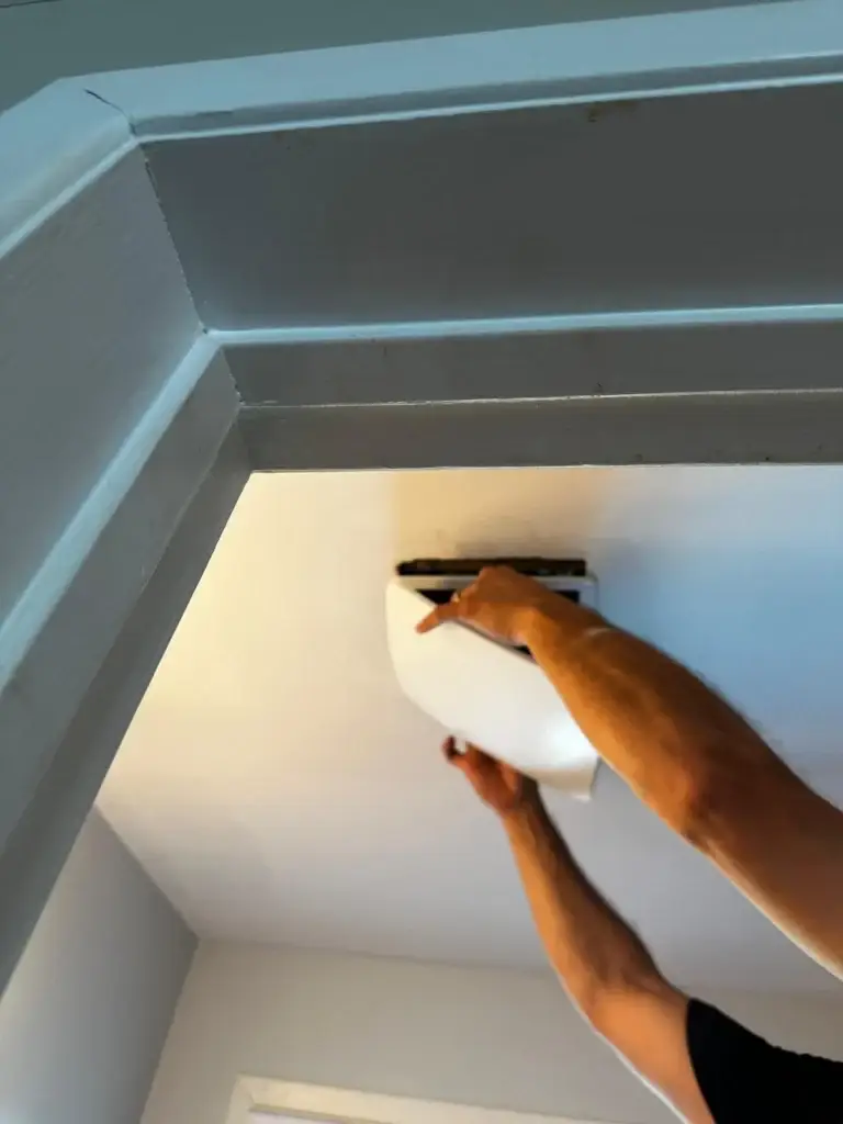 Fitting the round grille on the new bathroom exhaust fan