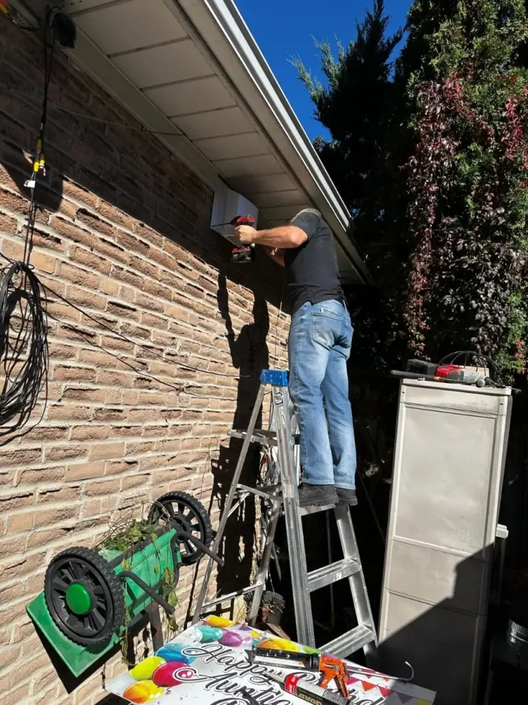 CNG technician installing the vent cap from a ladder