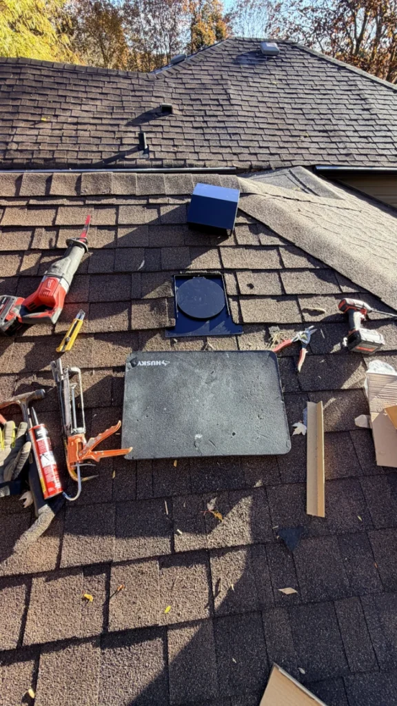 Roof vent cap and flashing ready to install on an asphalt shingle roof