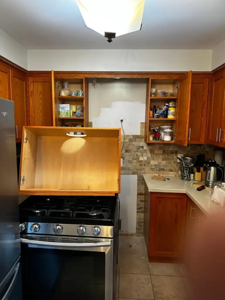 Toronto kitchen with wood cabinets before the range hood vent was redone