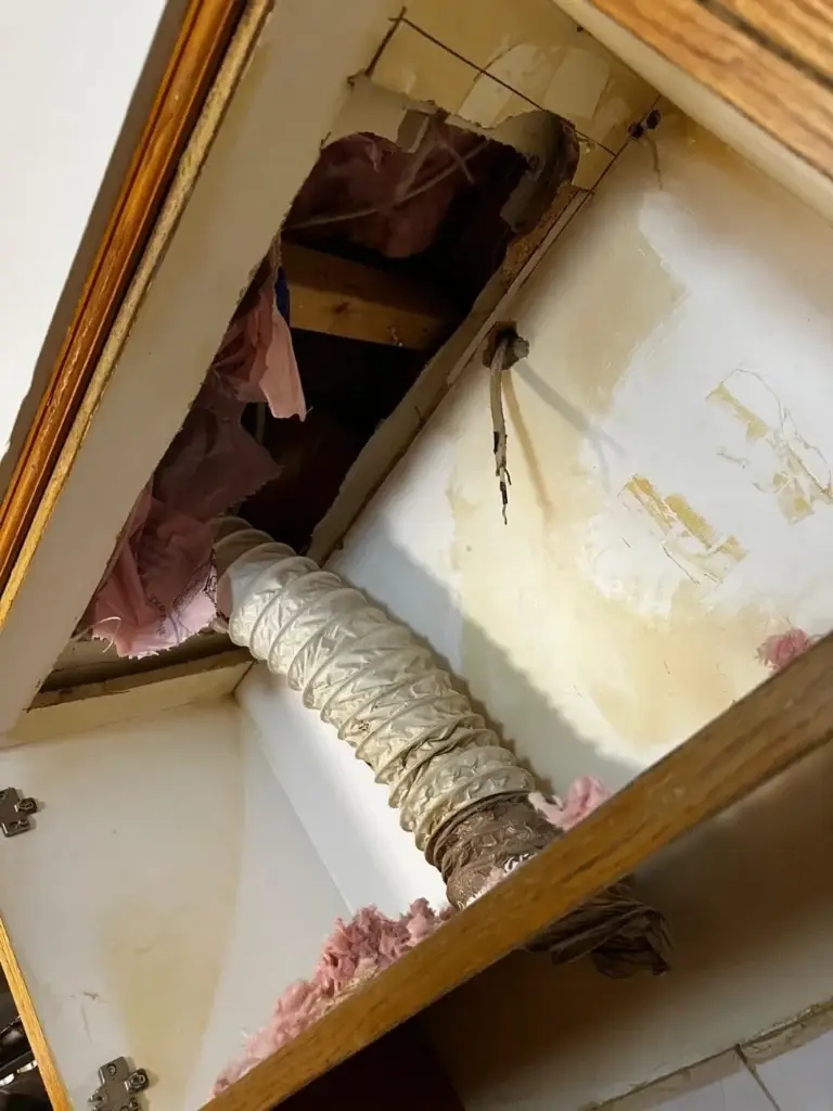 Old foil range hood duct running into the kitchen bulkhead