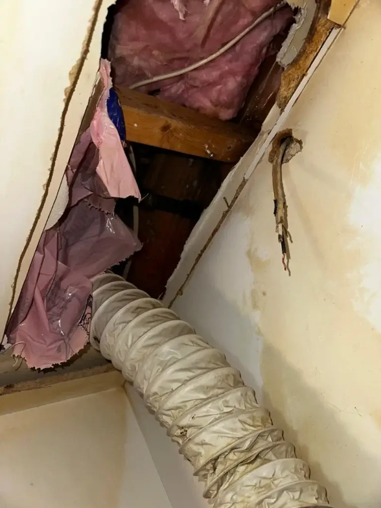 Loose foil duct and insulation inside the kitchen bulkhead