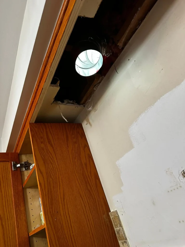 New duct opening through the bulkhead toward the exterior wall