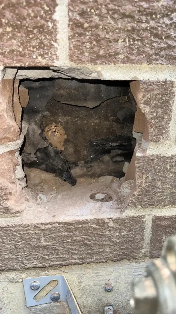 Opening cut through the brick for the new range hood duct