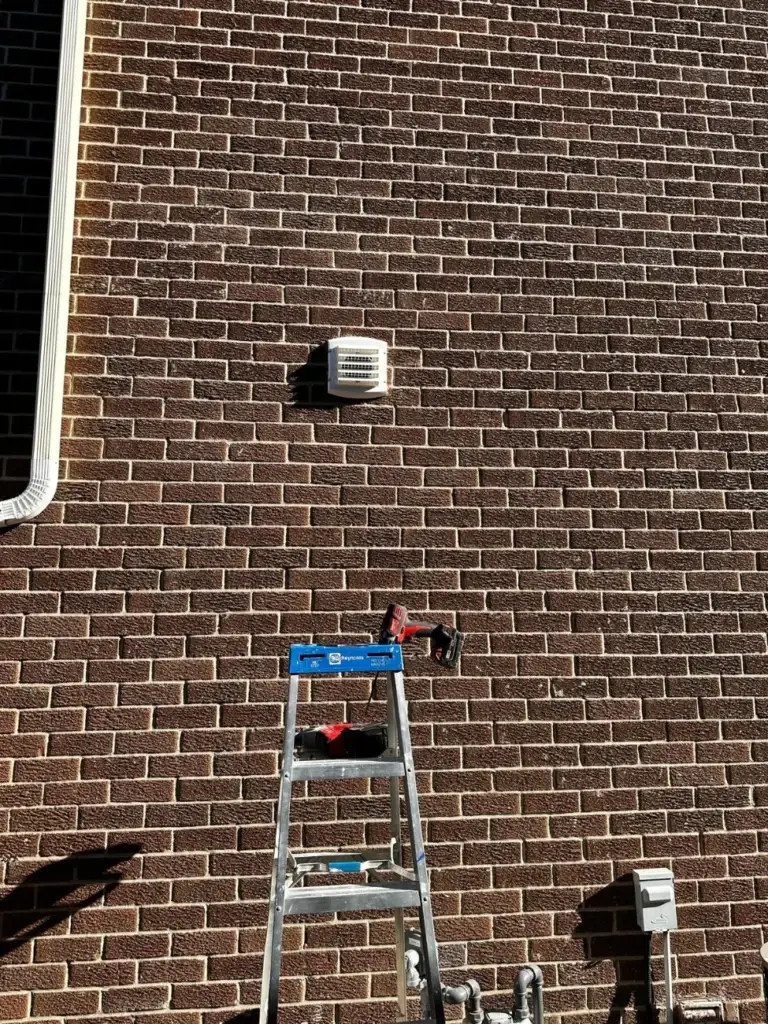 Brick wall of the Toronto home with the new range hood vent cap